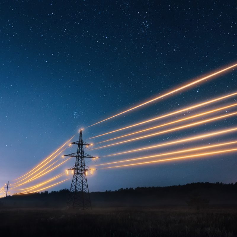 Electricity,Transmission,Towers,With,Orange,Glowing,Wires,The,Starry,Night